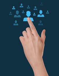 Image of Targeting, recruitment, customer acquisition. Woman touching virtual screen with human icons against dark teal background, closeup