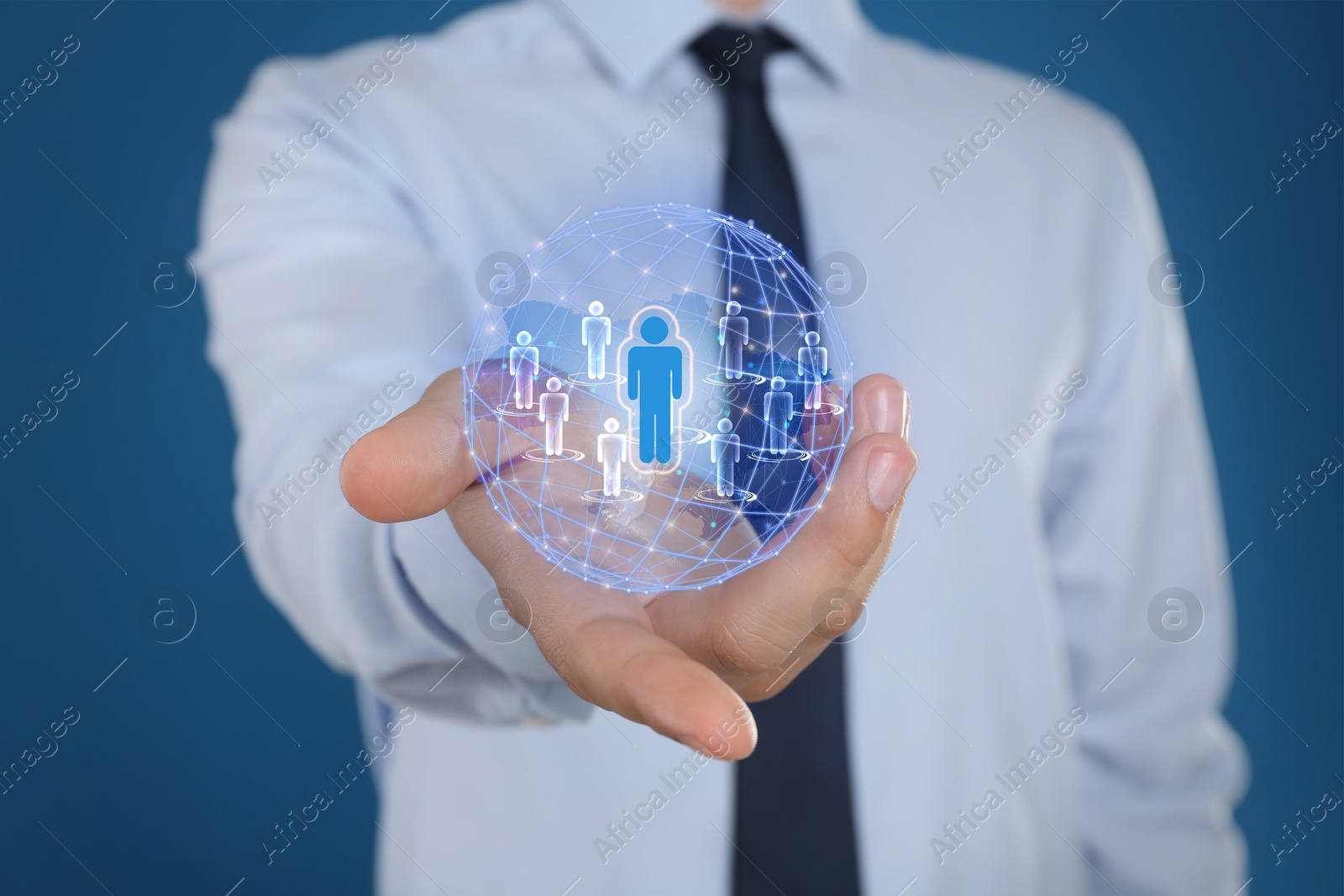 Image of Targeting, recruitment, customer acquisition. Businessman holding virtual globe with human icons against blue background, closeup