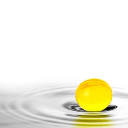 Image of Fish oil capsule in water on white background. Omega-3 fatty acids