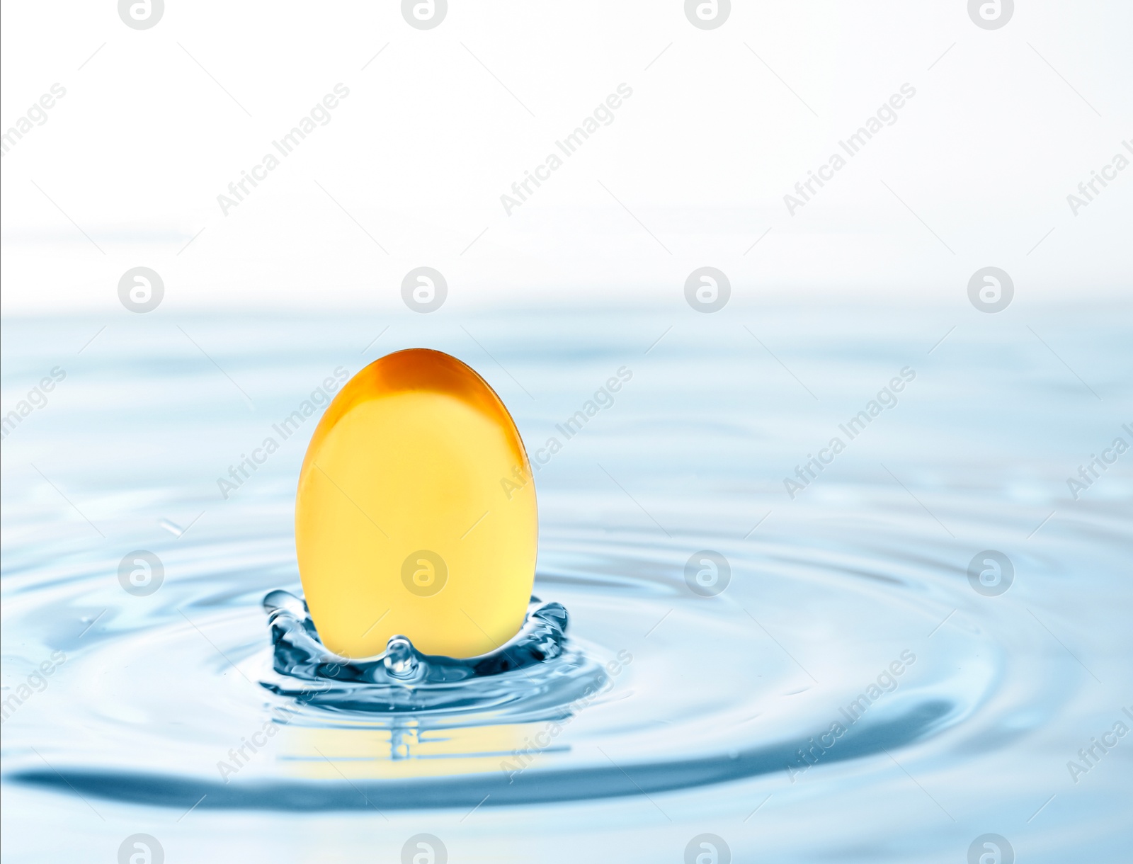 Image of Fish oil capsule in water on white background. Omega-3 fatty acids