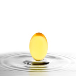 Fish oil capsule in water on white background. Omega-3 fatty acids