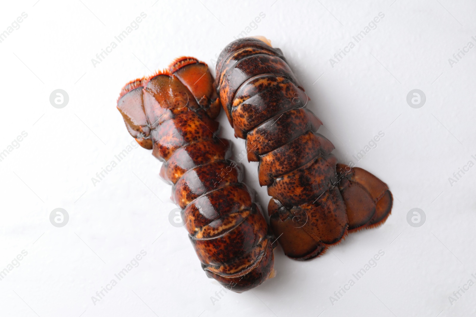 Raw lobster tails on white table, flat lay Photo of Raw lobster tails on white table, flat lay