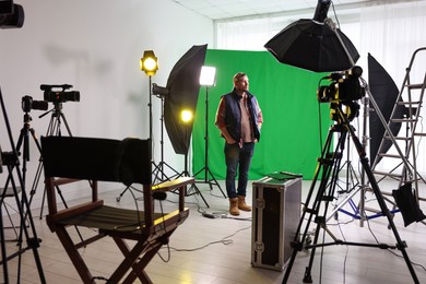 Photo of Man working in modern film studio with professional equipment