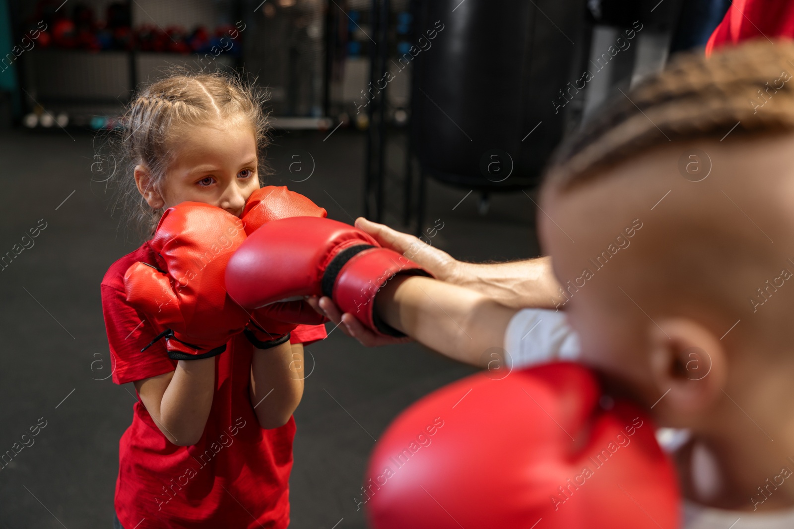 Photo of Children having boxing practice in training center