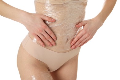 Photo of Woman doing spa body wraps on her belly against white background, closeup