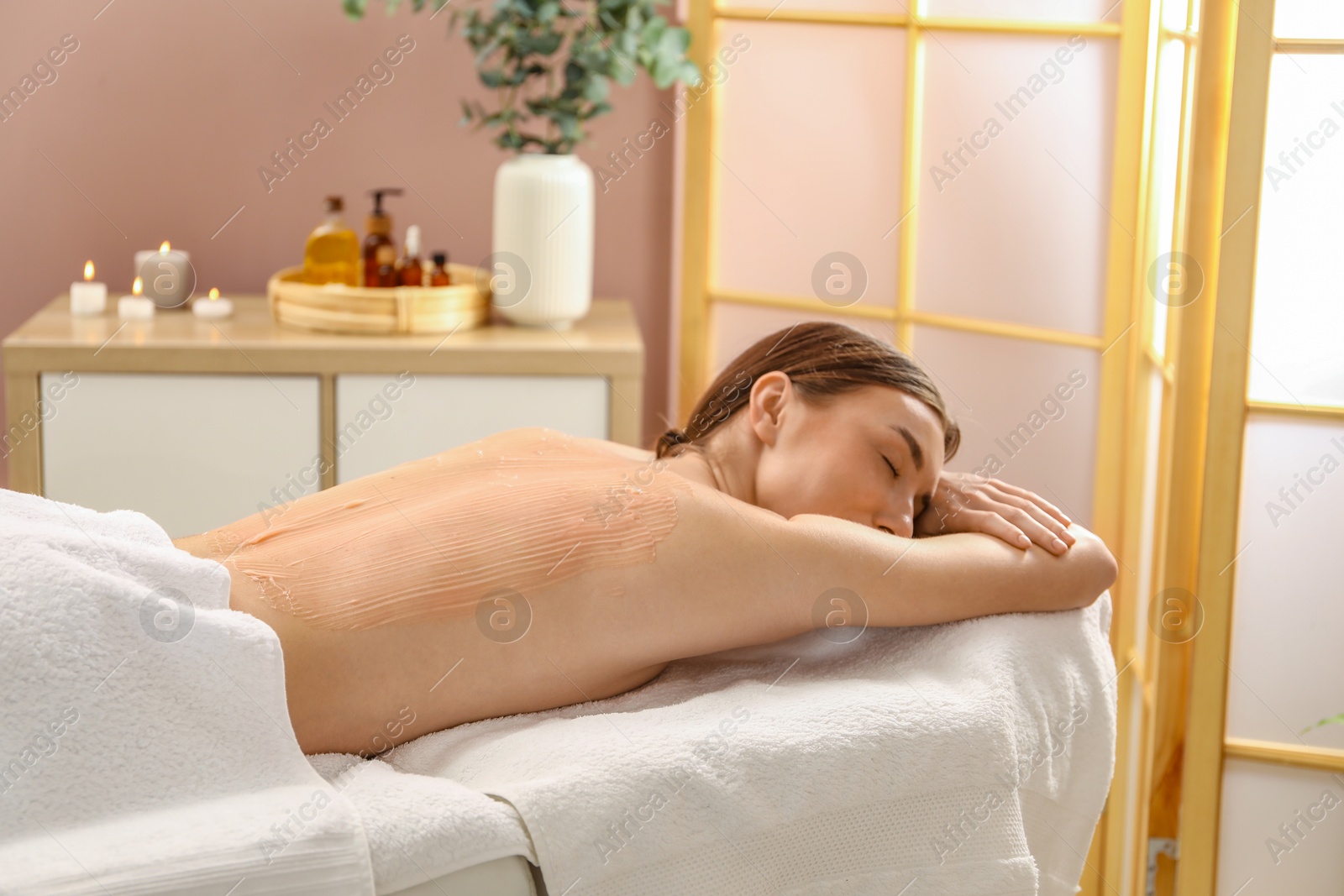 Photo of Woman undergoing body wraps treatment in spa salon