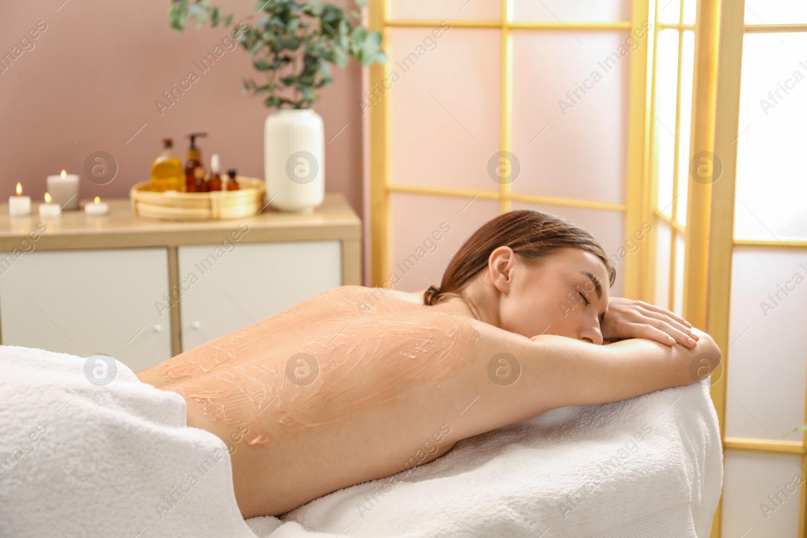 Photo of Woman undergoing body wraps treatment in spa salon