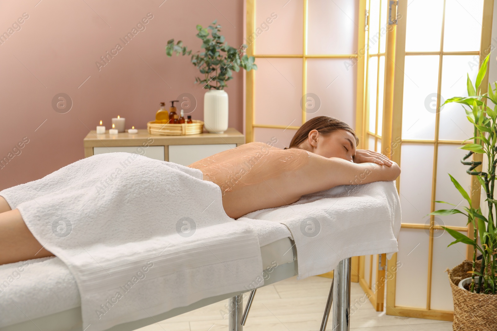 Photo of Woman undergoing body wraps treatment in spa salon