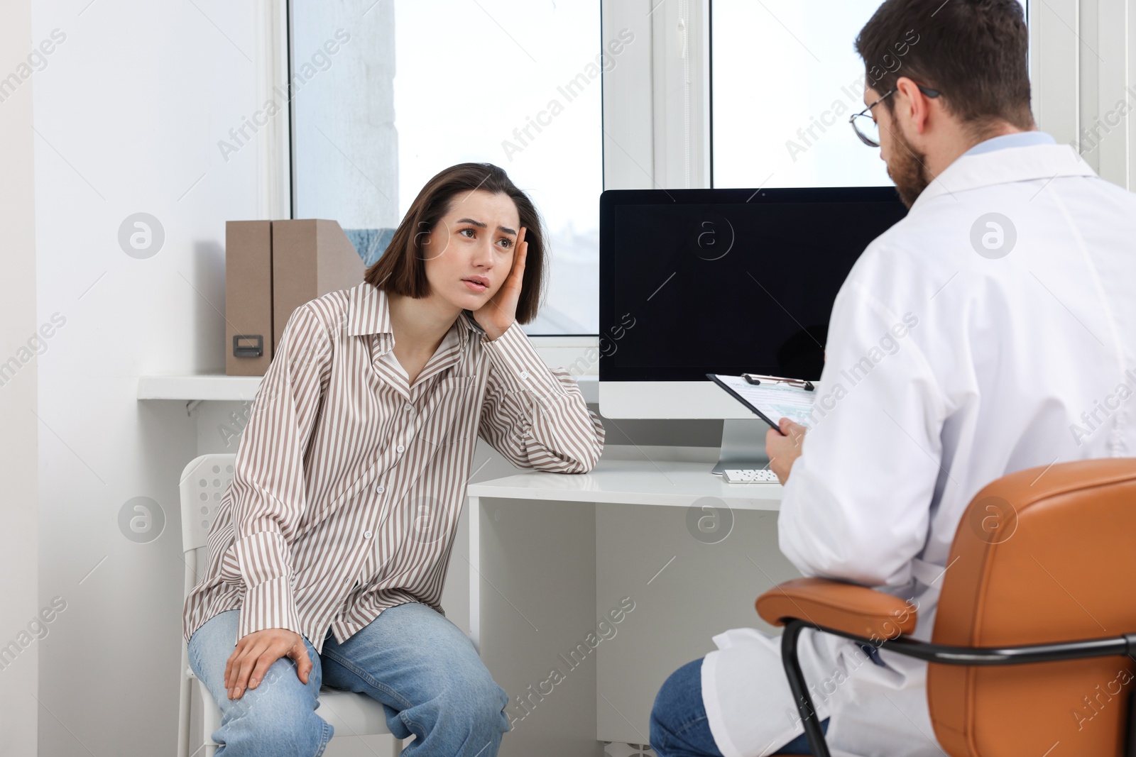 Photo of Dependent woman having appointment with addiction specialist in clinic