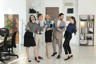 Portrait of happy coworkers in formal clothes indoors