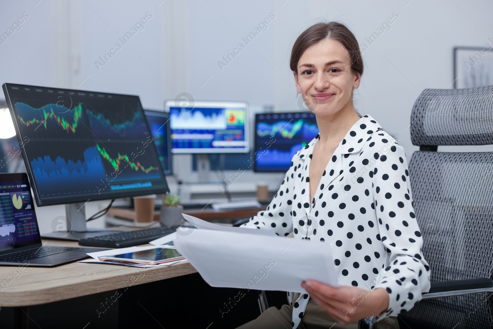 Photo of Stock exchange. Woman working at desk in office