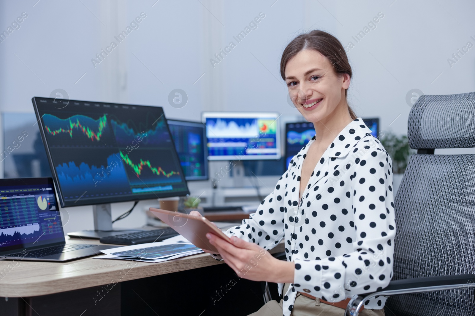 Photo of Stock exchange. Woman working at desk in office