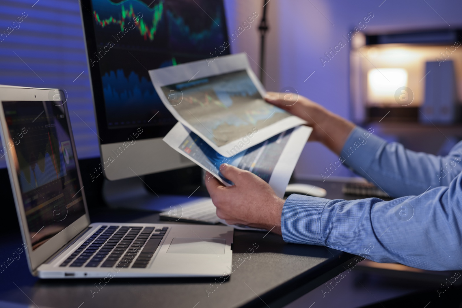 Photo of Stock exchange. Man working in office at night, closeup