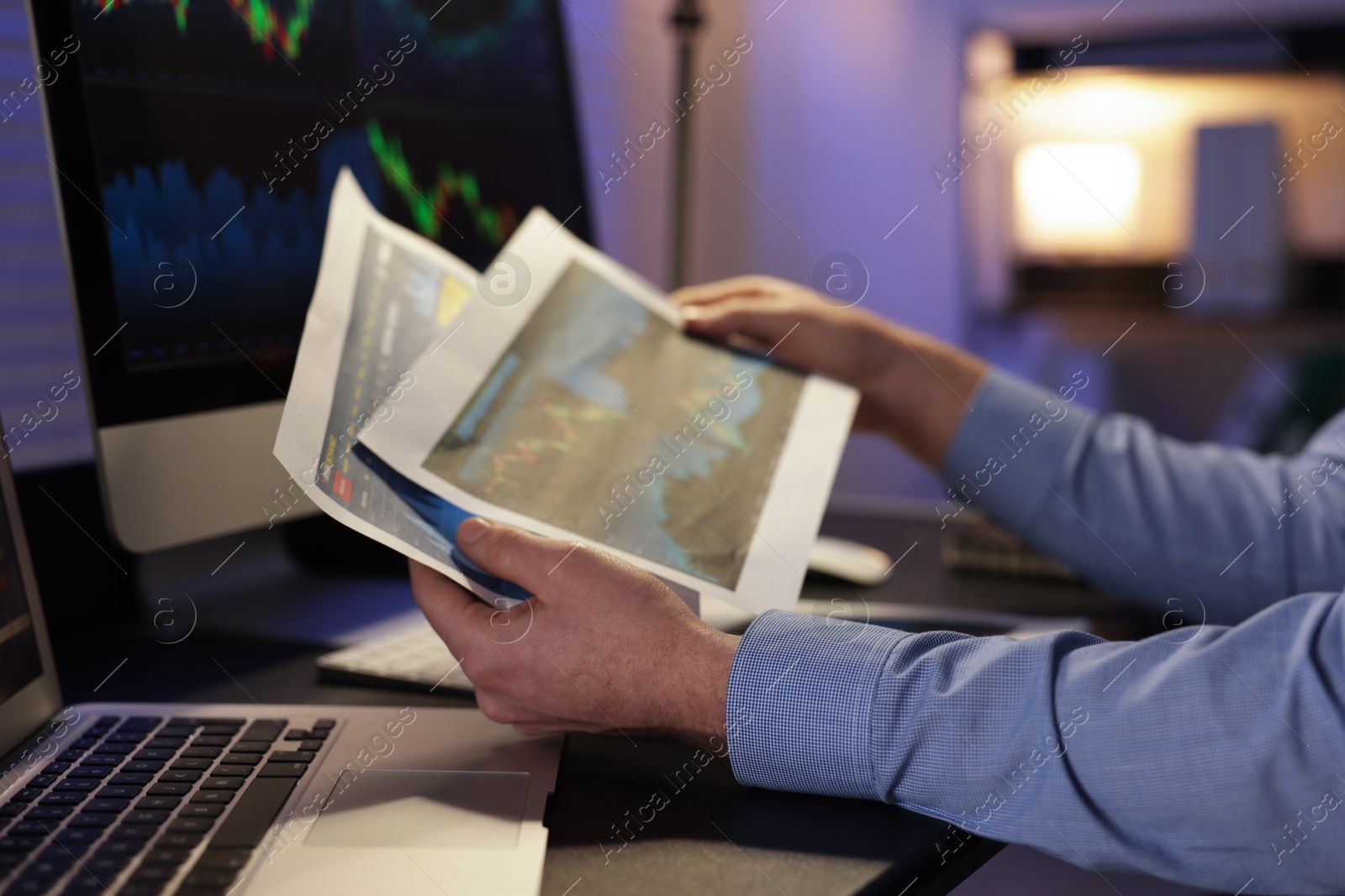 Photo of Stock exchange. Man working in office at night, closeup