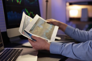 Photo of Stock exchange. Man working in office at night, closeup