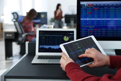 Stock exchange. Man working at desk in office, closeup