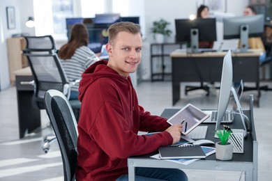 Photo of Stock exchange. Man working at desk in office