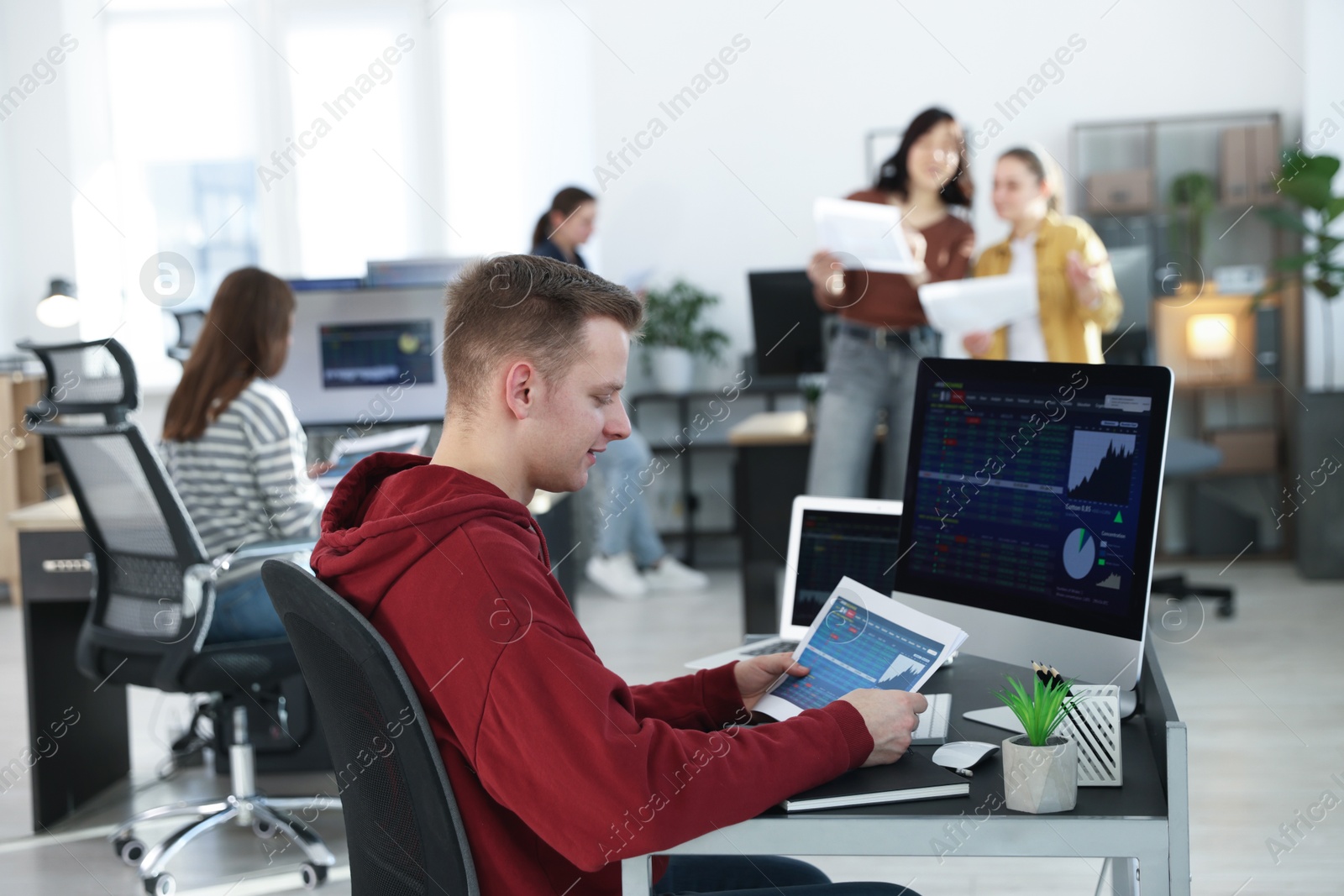 Photo of Stock exchange. Man working at desk in office