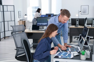 Photo of Stock exchange. Colleagues working together in office