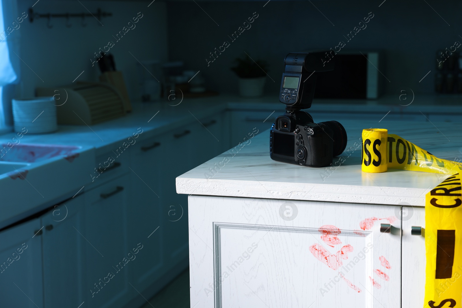 Photo of Camera, yellow crime scene tape and bloody handprint on chest of drawers in kitchen. Forensic expertise