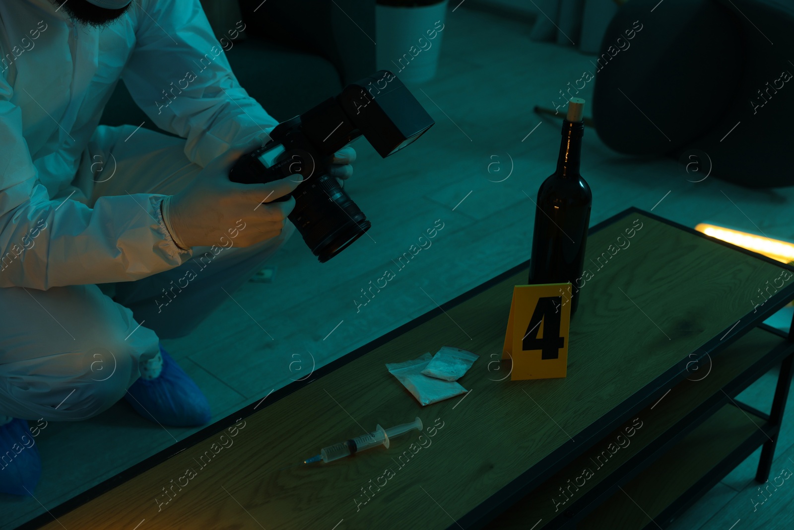 Photo of Forensic expert with camera taking photo of evidences at crime scene indoors, closeup