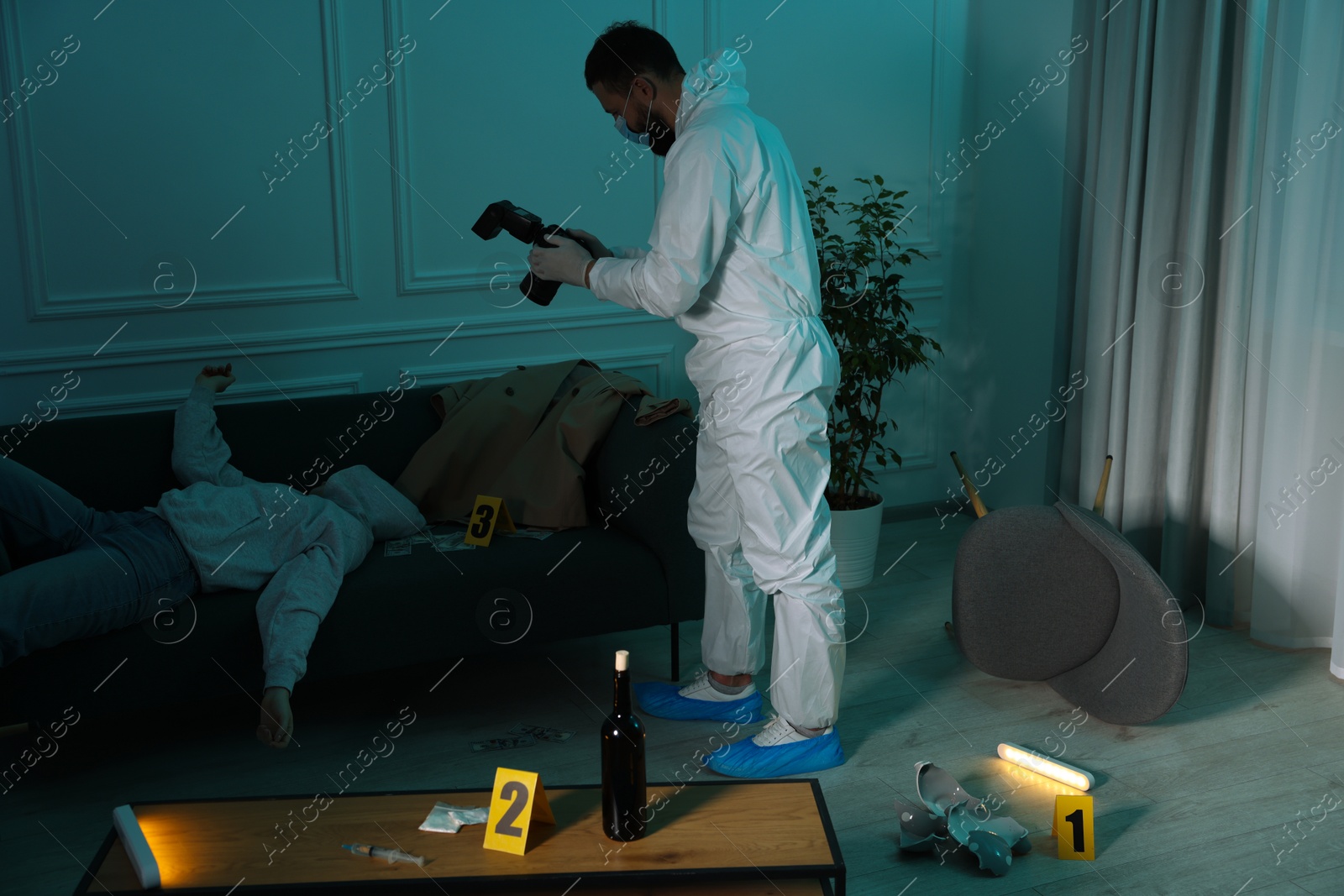 Photo of Forensic expert with camera working at crime scene and dead woman's body indoors