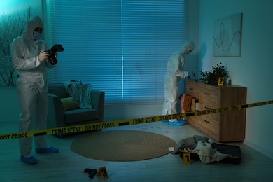 Forensic experts working at crime scene indoors