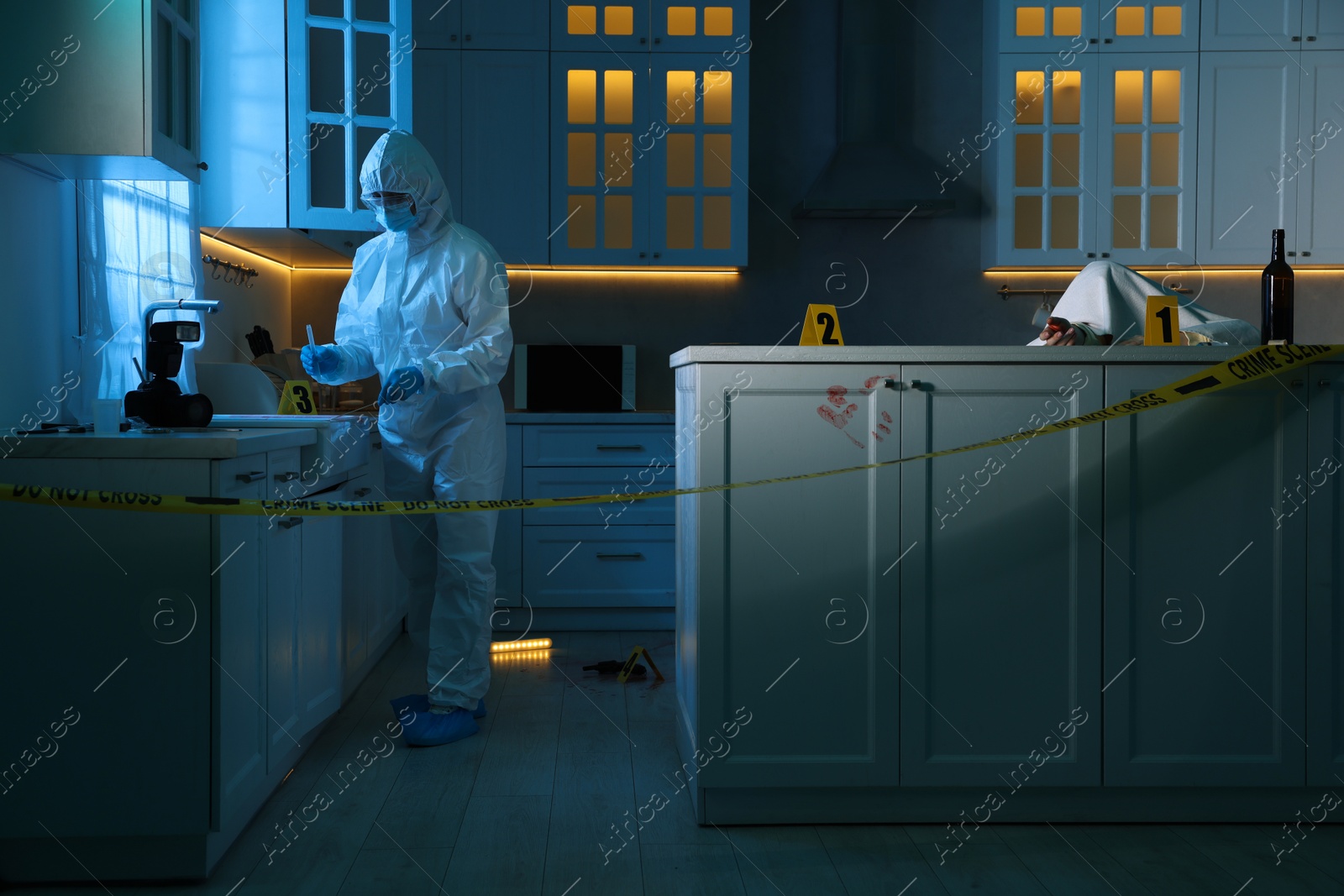 Photo of Forensic expert working at crime scene and dead body in dark room