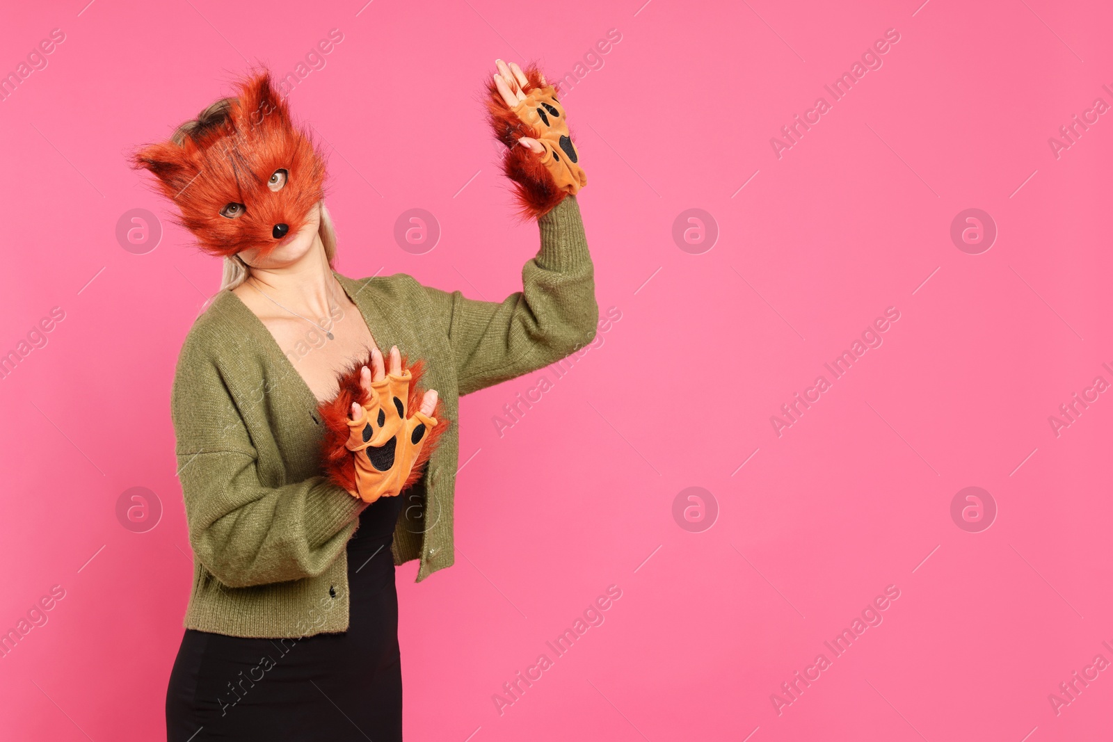 Photo of Quadrobics. Woman wearing fox mask and gloves on pink background, space for text