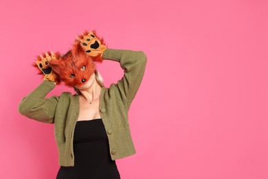 Quadrobics. Woman wearing fox mask and gloves on pink background, space for text