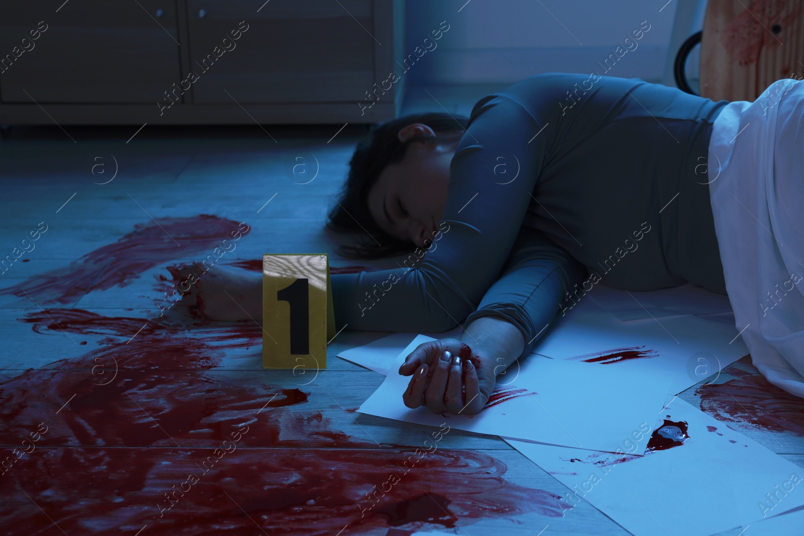 Photo of Crime scene with dead woman's body indoors