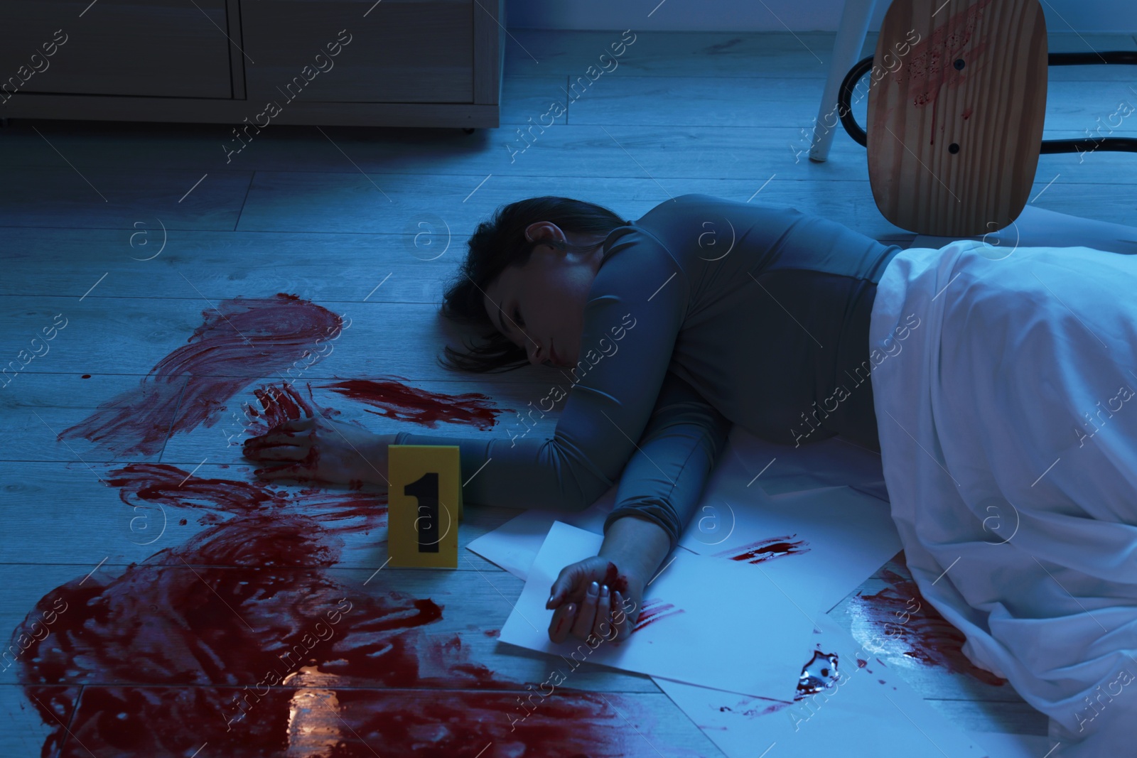 Photo of Crime scene with dead woman's body indoors