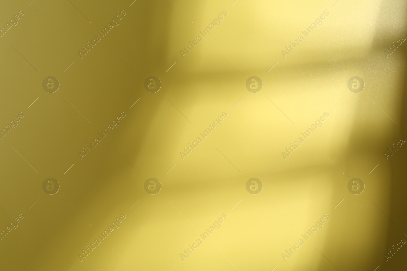 Photo of Light and shadow falling on yellow background