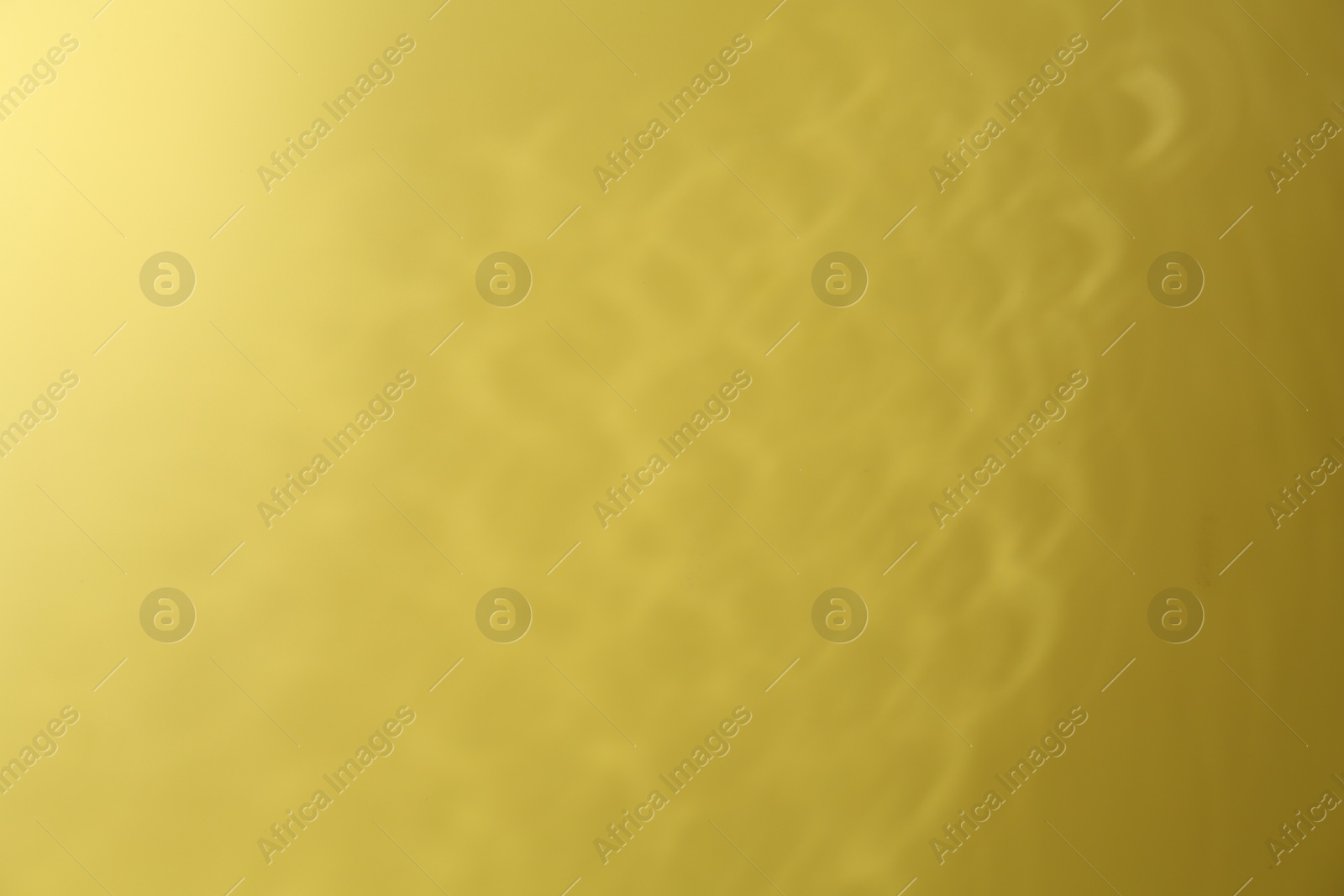 Photo of Light and shadow falling on yellow background