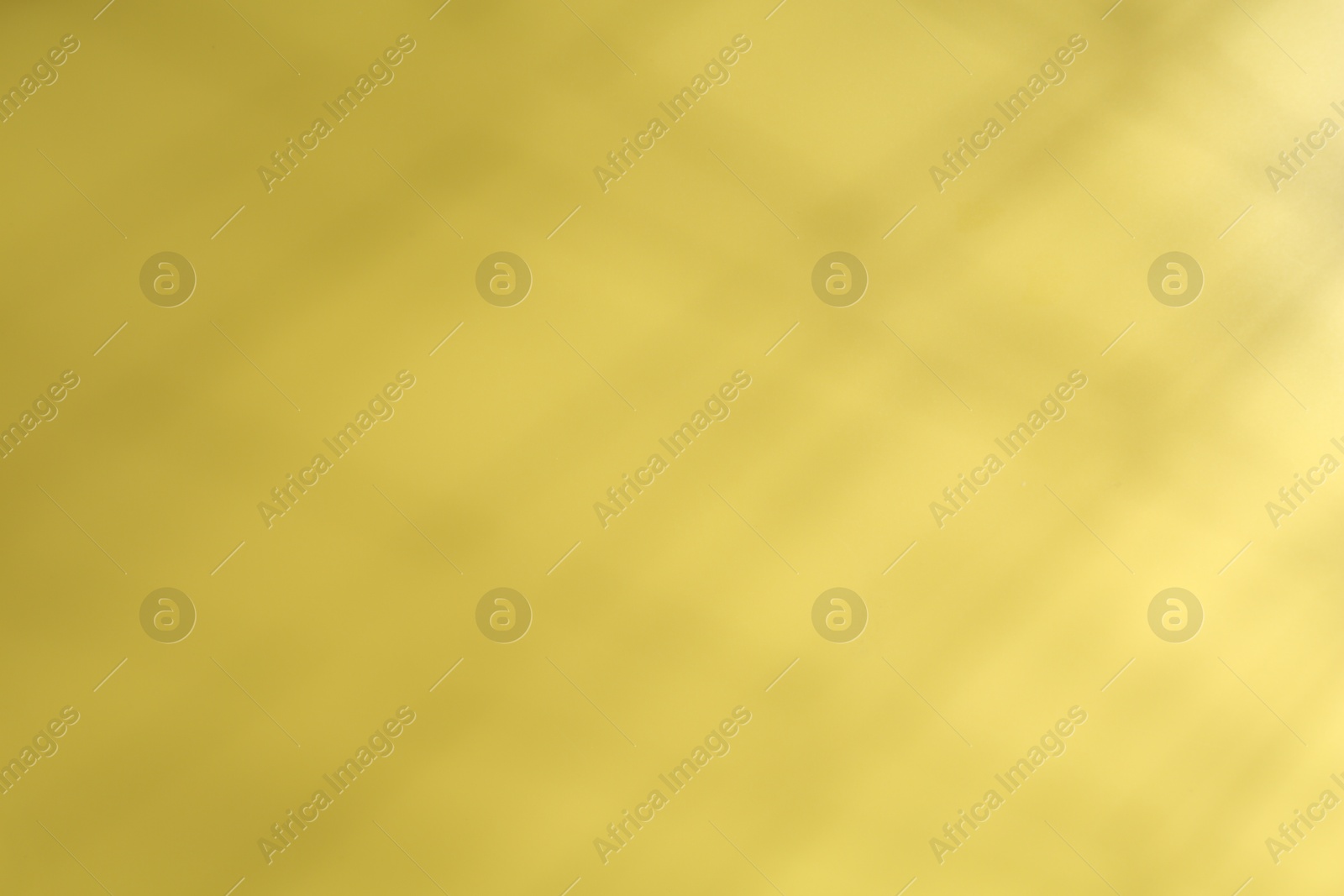 Photo of Light and shadow falling on yellow background