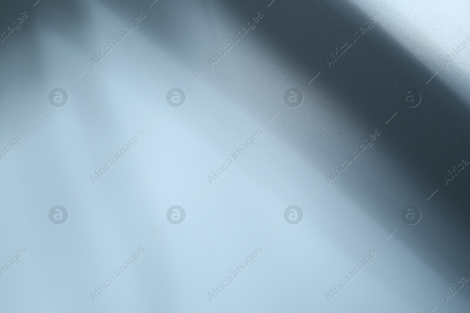 Photo of Light and shadows falling on white background