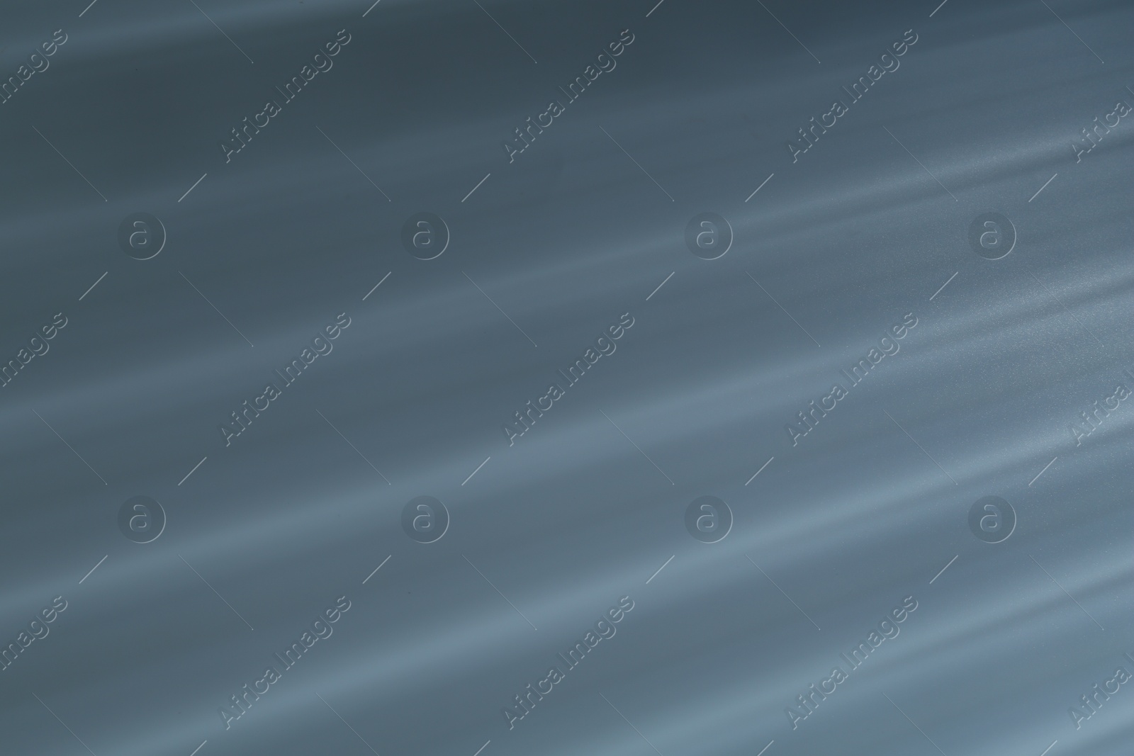 Photo of Light and shadows falling on grey background