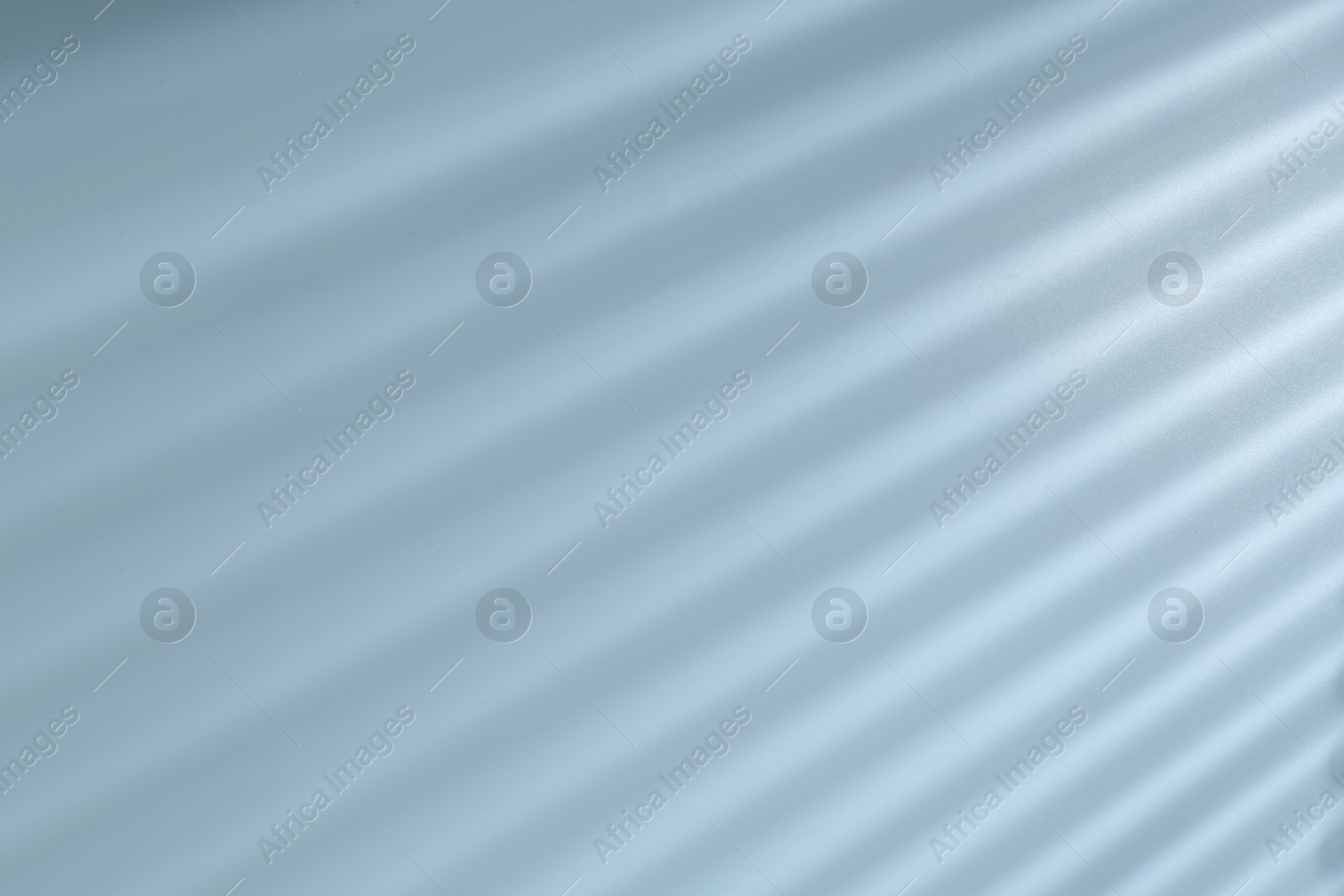 Photo of Light and shadows falling on grey background