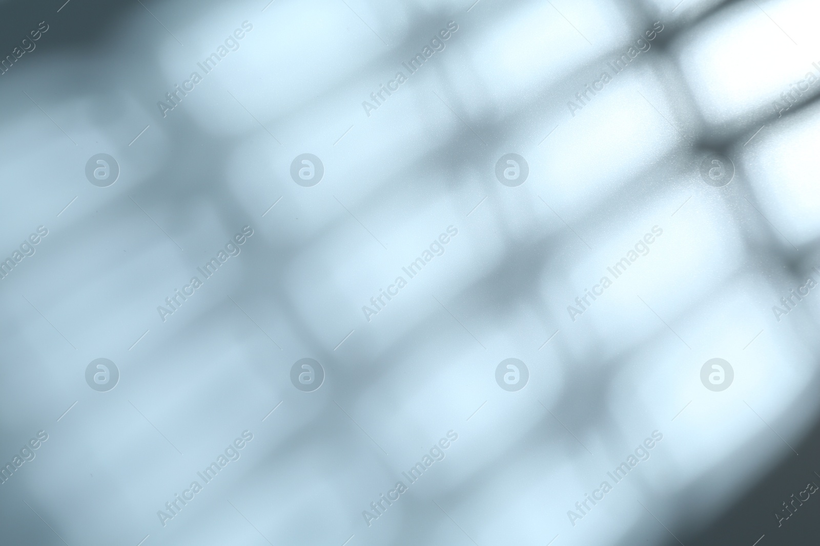 Photo of Light and shadows falling on grey background