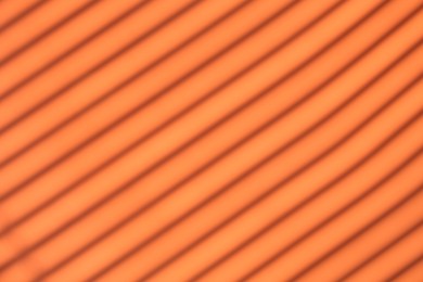 Light and shadows falling on orange background