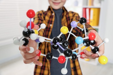 Photo of Boy with DNA structure model indoors, closeup