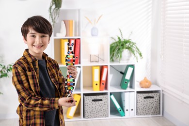 Photo of Smiling boy with DNA structure model indoors. Space for text