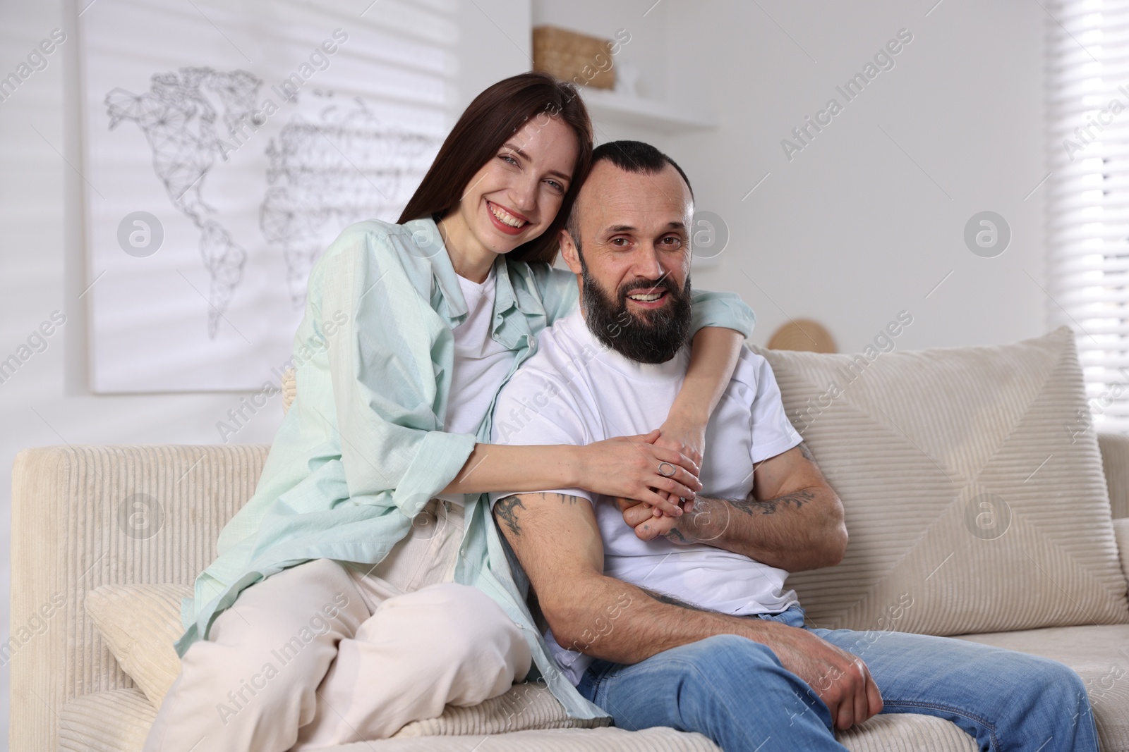 Photo of Portrait of happy daughter and father on sofa at home