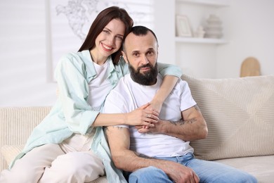 Photo of Portrait of happy daughter and father on sofa at home