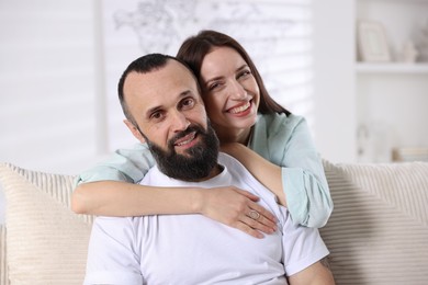 Photo of Portrait of happy daughter and father on sofa at home