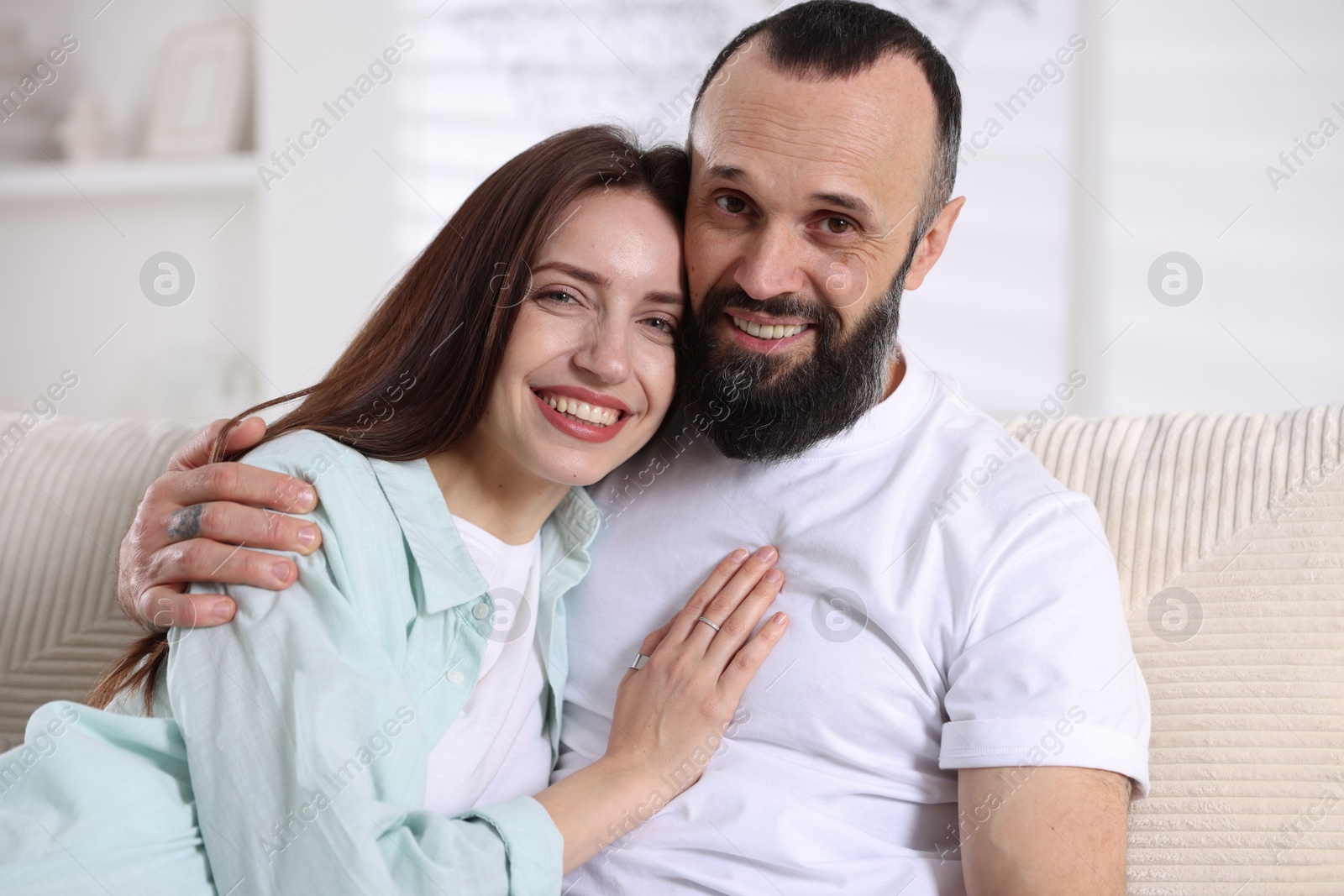 Photo of Portrait of happy daughter and father on sofa at home