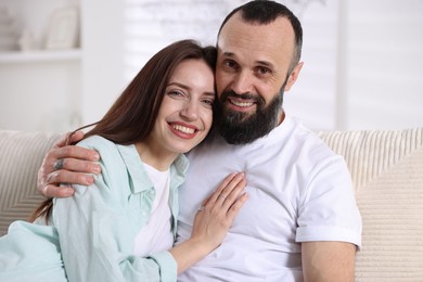 Photo of Portrait of happy daughter and father on sofa at home