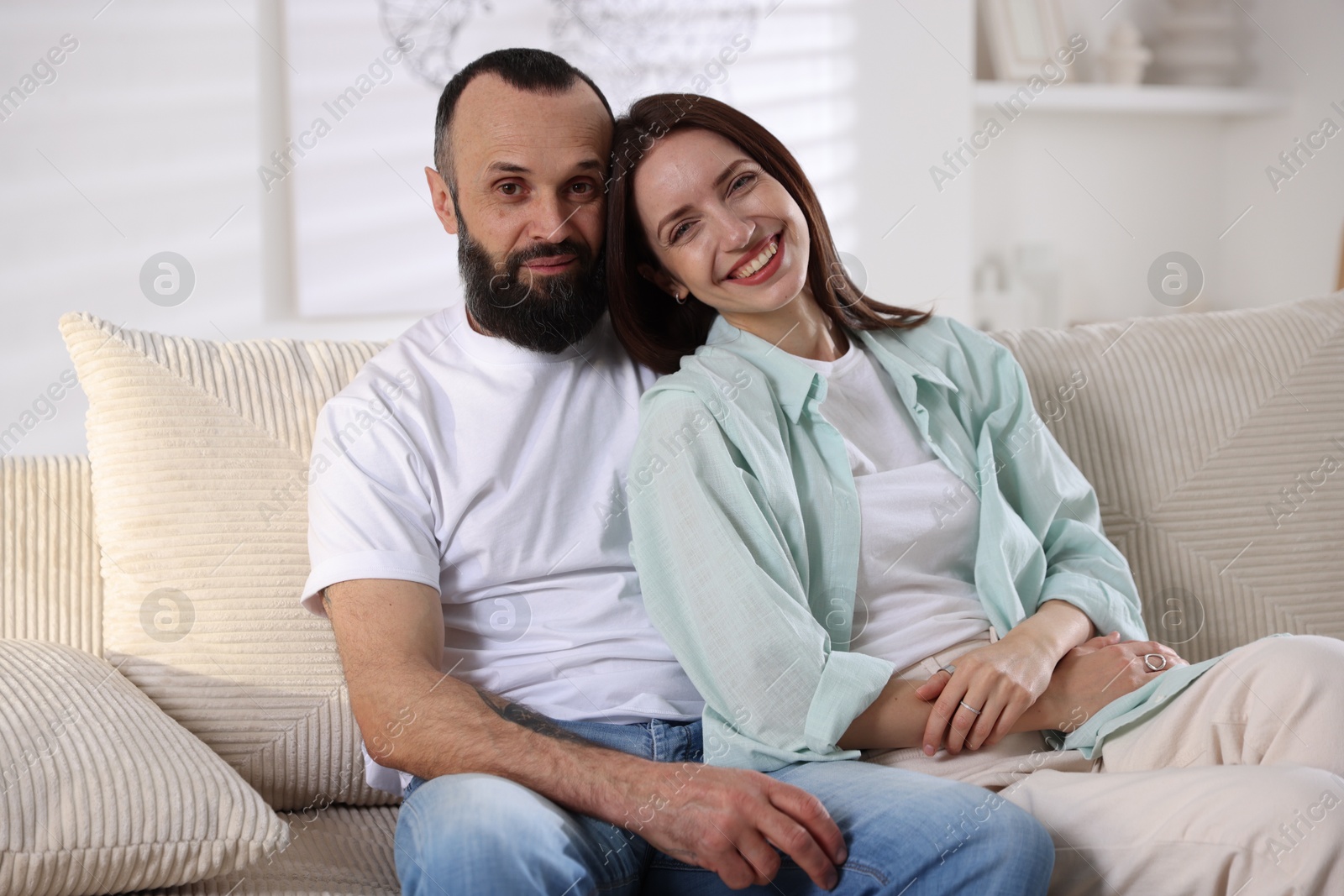 Photo of Portrait of happy daughter and father on sofa at home