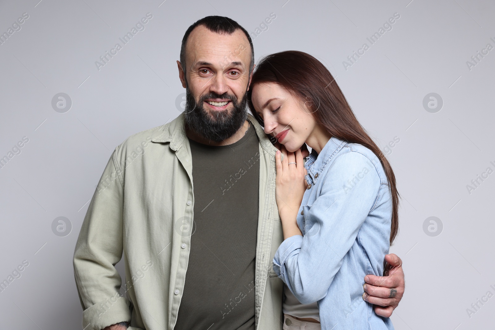 Photo of Happy daughter and father on light grey background