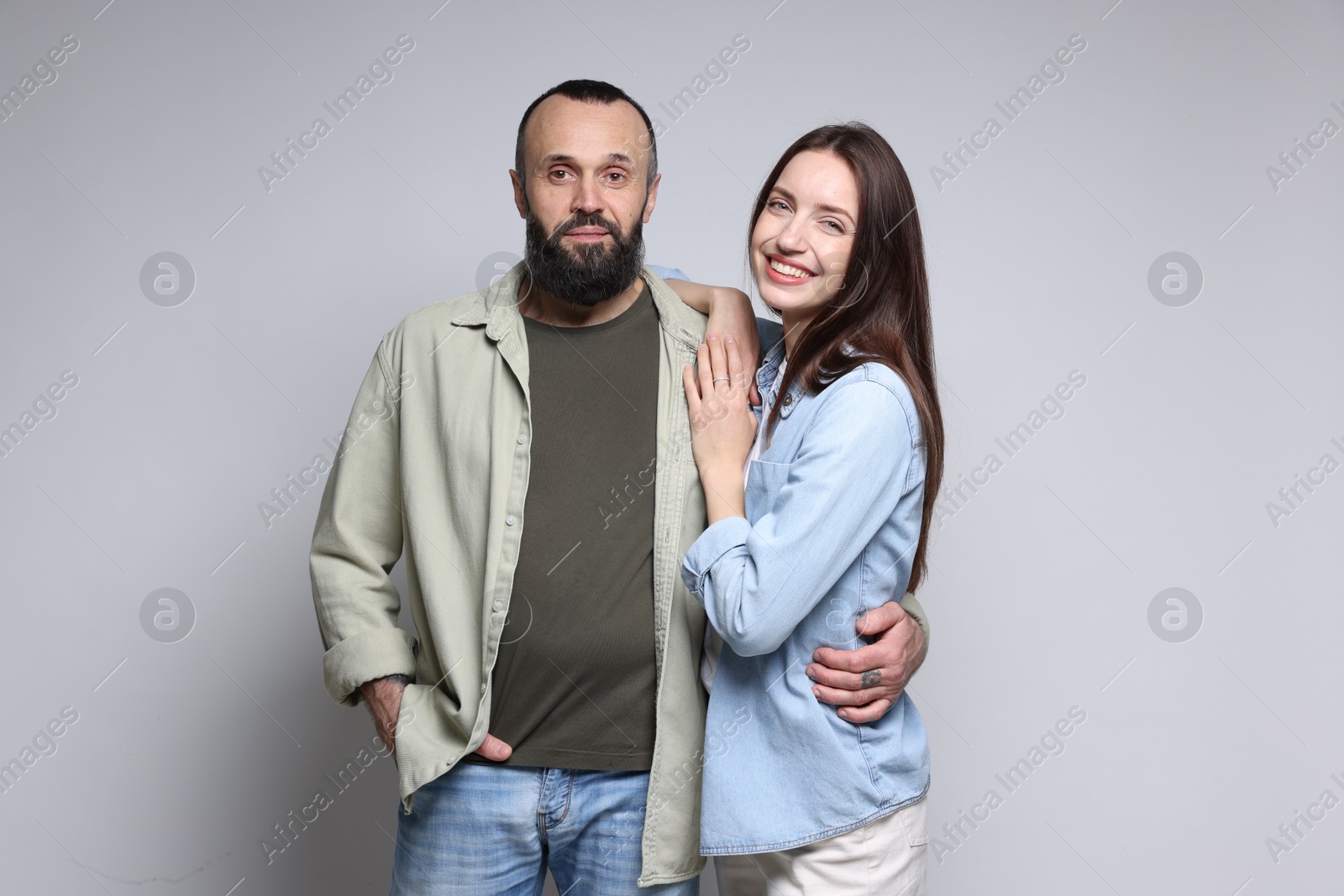 Photo of Portrait of happy daughter and father on light grey background